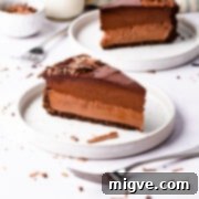 Sinfully Decadent Cheesecake 12 an individual slice of devil's food cheesecake on a plate with fork in front of it.