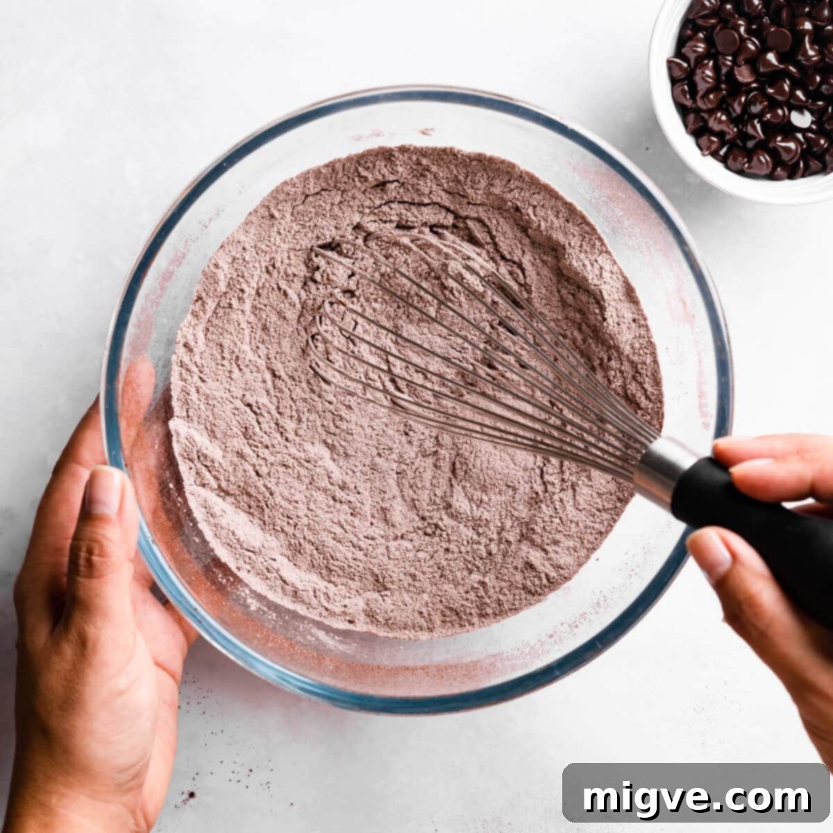 Bandaged Boo Cupcakes 4 Dry ingredients being thoroughly mixed with a whisk in a large mixing bowl, ensuring an even distribution.