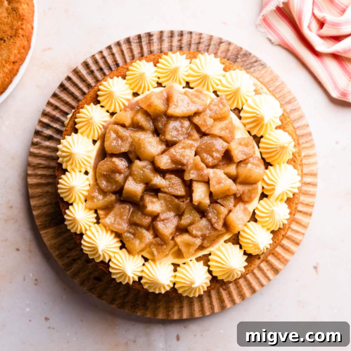 a layer of spiced apple filling on top of the buttercream on a sponge cake.