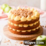 apple crumble cake topped with custard buttercream and crumble.