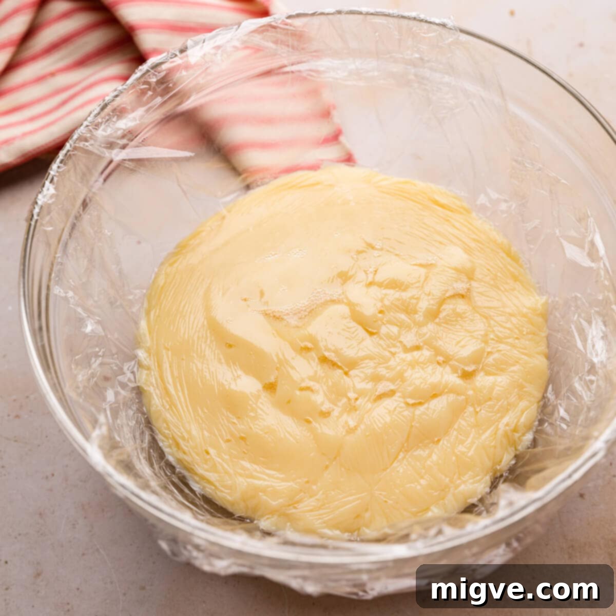 a large bowl with custard covered with clingfilm.