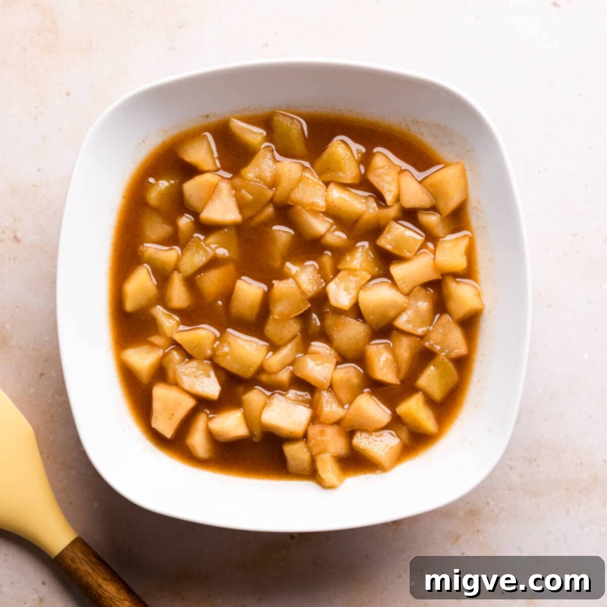 bowl with stewed apples in cooking juices.