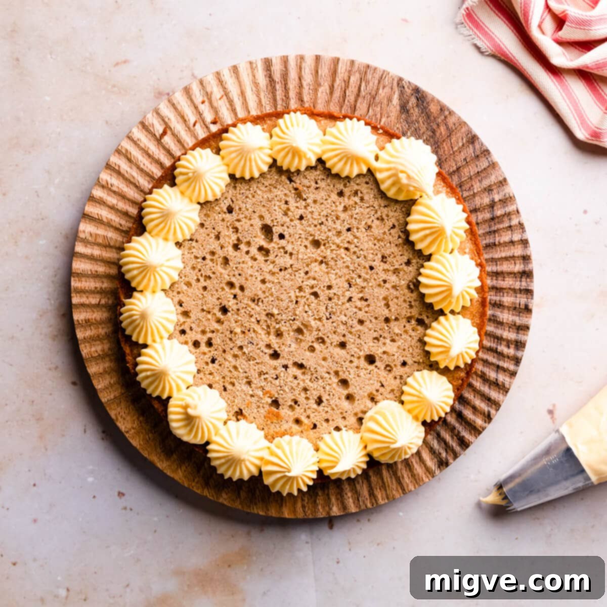 custard buttercream piped around the apple crumble cake sponge.