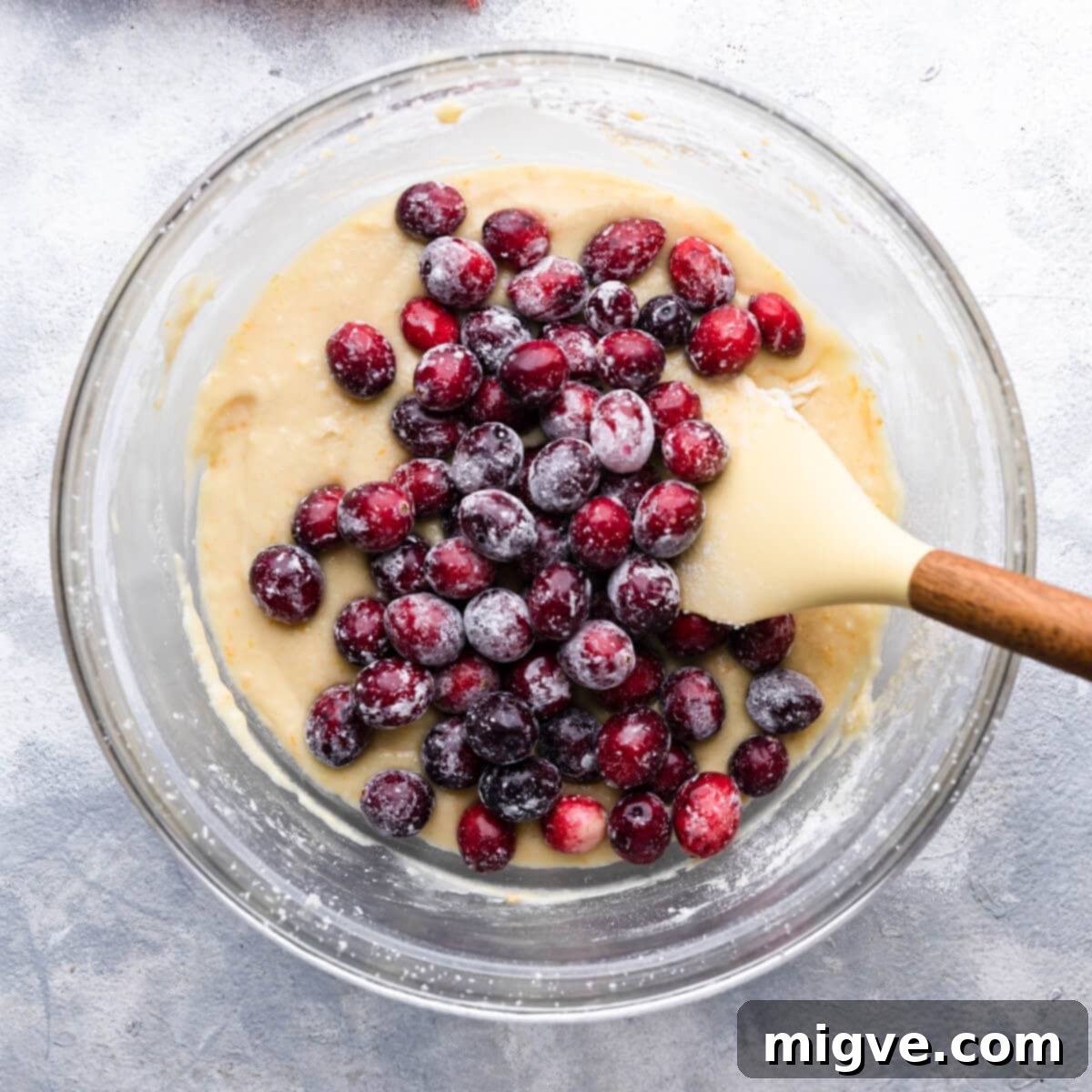 cranberries added to the bowl with cake batter.