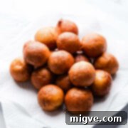 tofu mini doughnuts balls on a plate with paper towel.