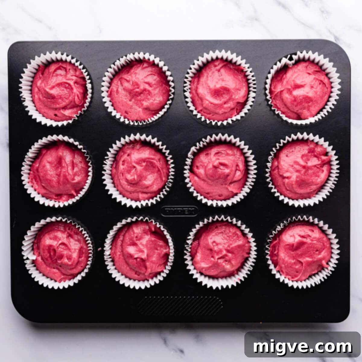 Decadent Raspberry Chocolate Cupcakes 6 pink cupcake batter inside of the cupcake liners and baking tin, ready for the oven.