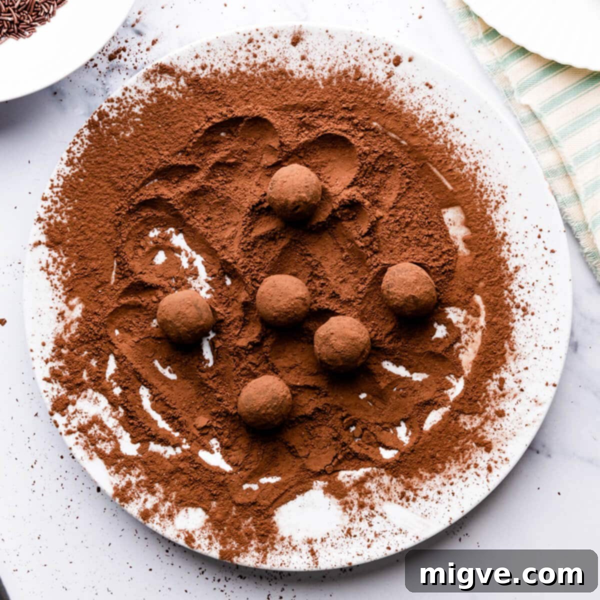 salted caramel truffles rolled in cocoa powder on a large plate.