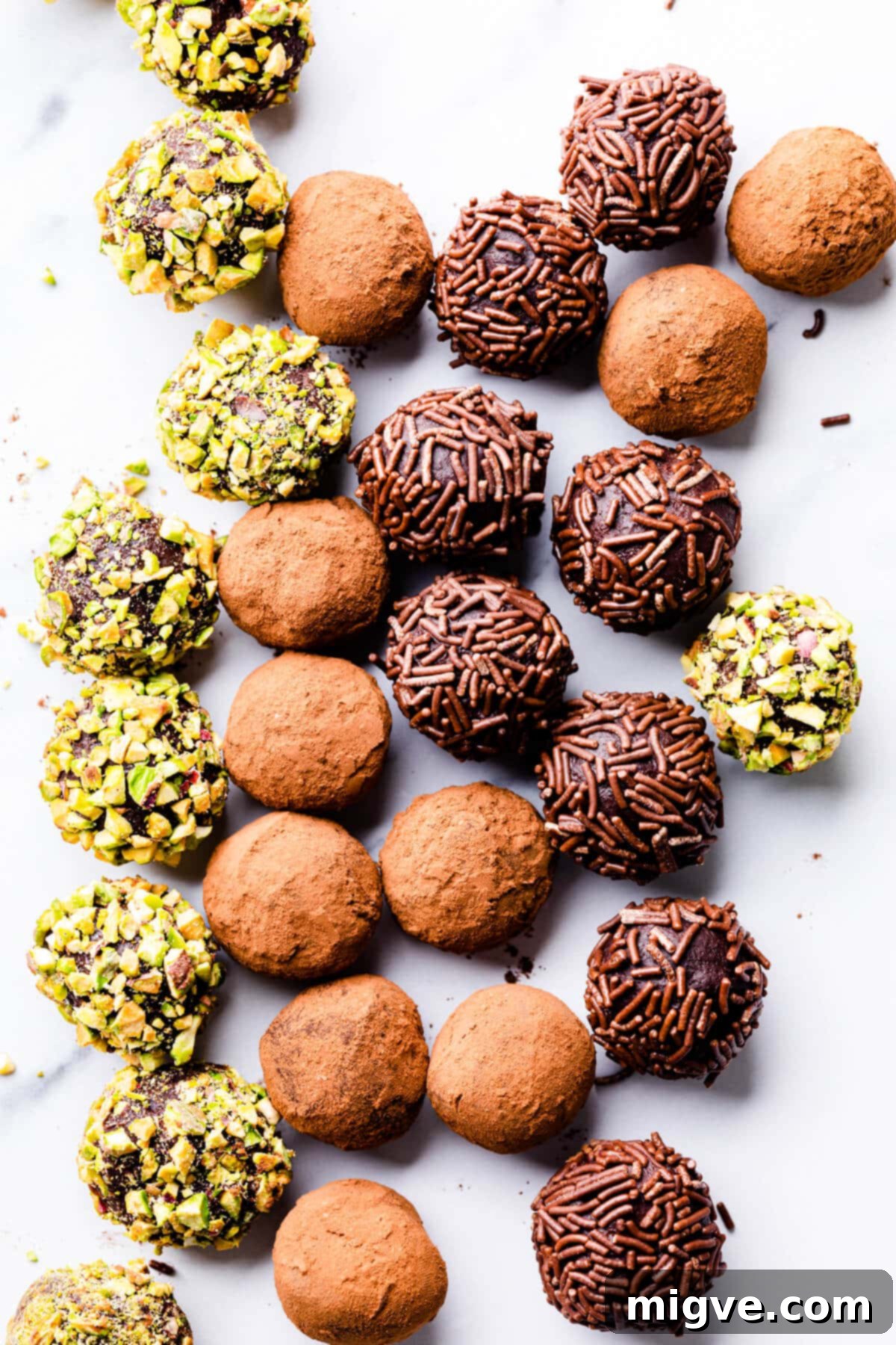 salted caramel truffles in selection of coatings on a white surface.