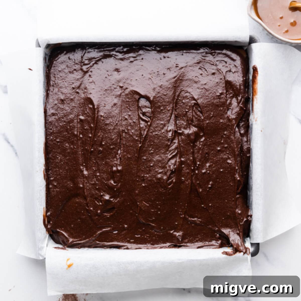 guinness brownie batter in the baking tin.