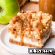a single square slice of apple caramel cheesecake on a small plate.