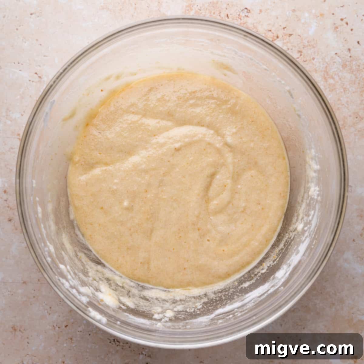 large glass bowl with mixed batter for financiers.