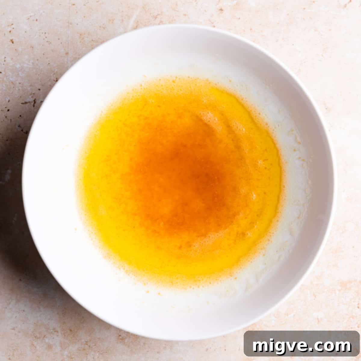 small ceramic bowl with browned butter inside.