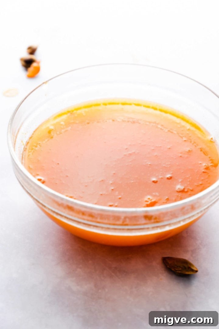 side close up view of a glass bowl filled with homemade apricot nectar