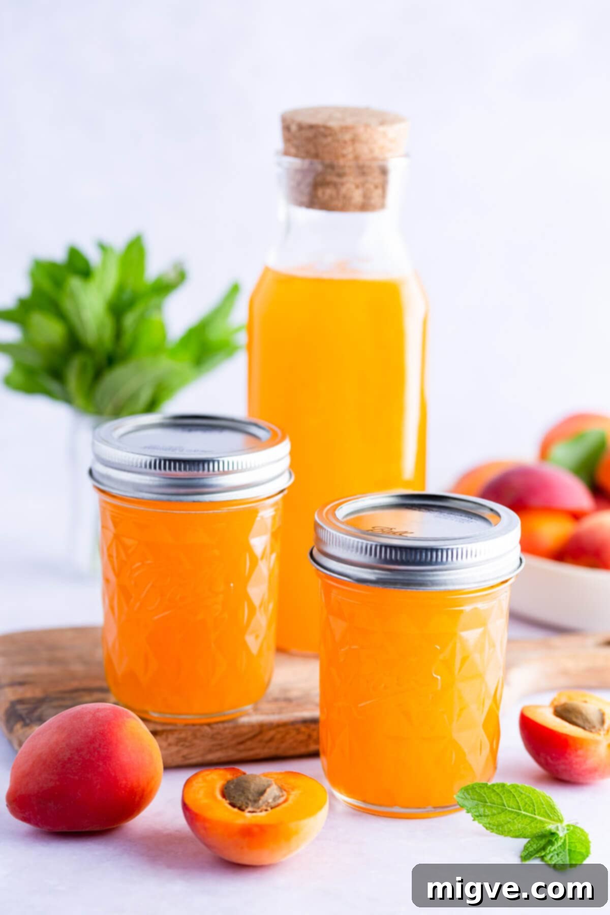 side view of 2 small glass jars and one glass bottle with apricot nectar