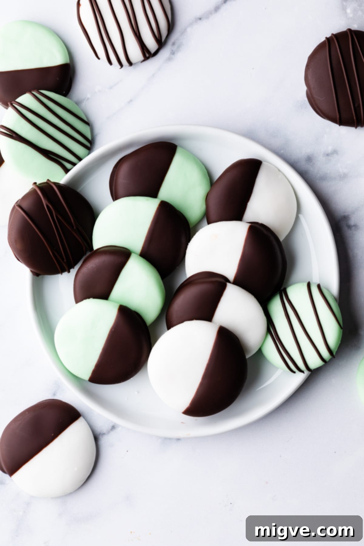 mint creams sweets with chocolate dip on a small plate.