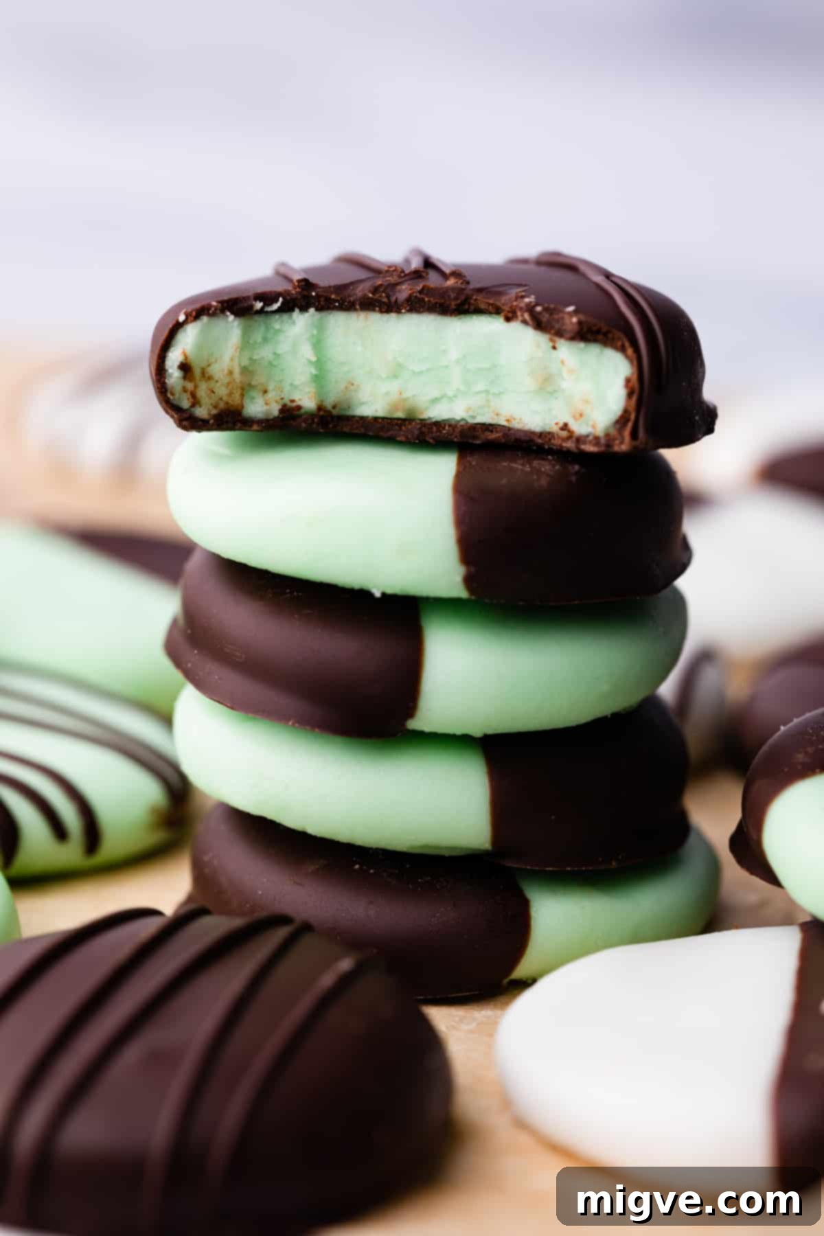 stack of peppermint sweets covered and dipped in chocolate with the top one missing a bite.