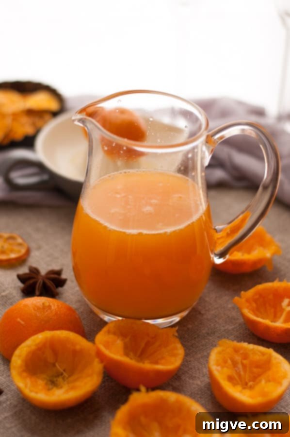 Zesty Clementine and Cranberry Cordial 3 Clementine and Cranberry Cordial bottle on a wooden surface