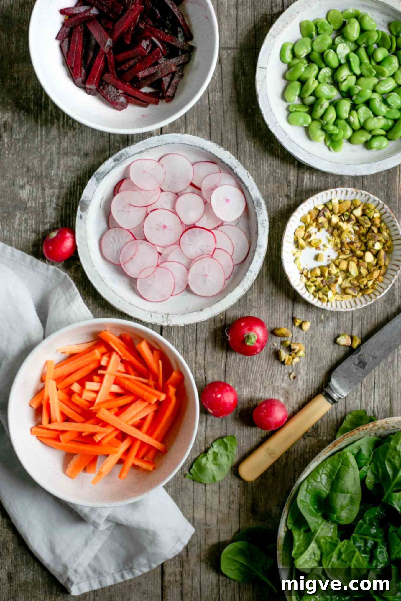 Delicious spinach and beetroot salad brimming with a variety of fresh vegetables, promoting clean eating and a healthy vegan lifestyle.