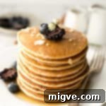 Delicious and light silken tofu pancakes with maple syrup and berries, ready to be enjoyed