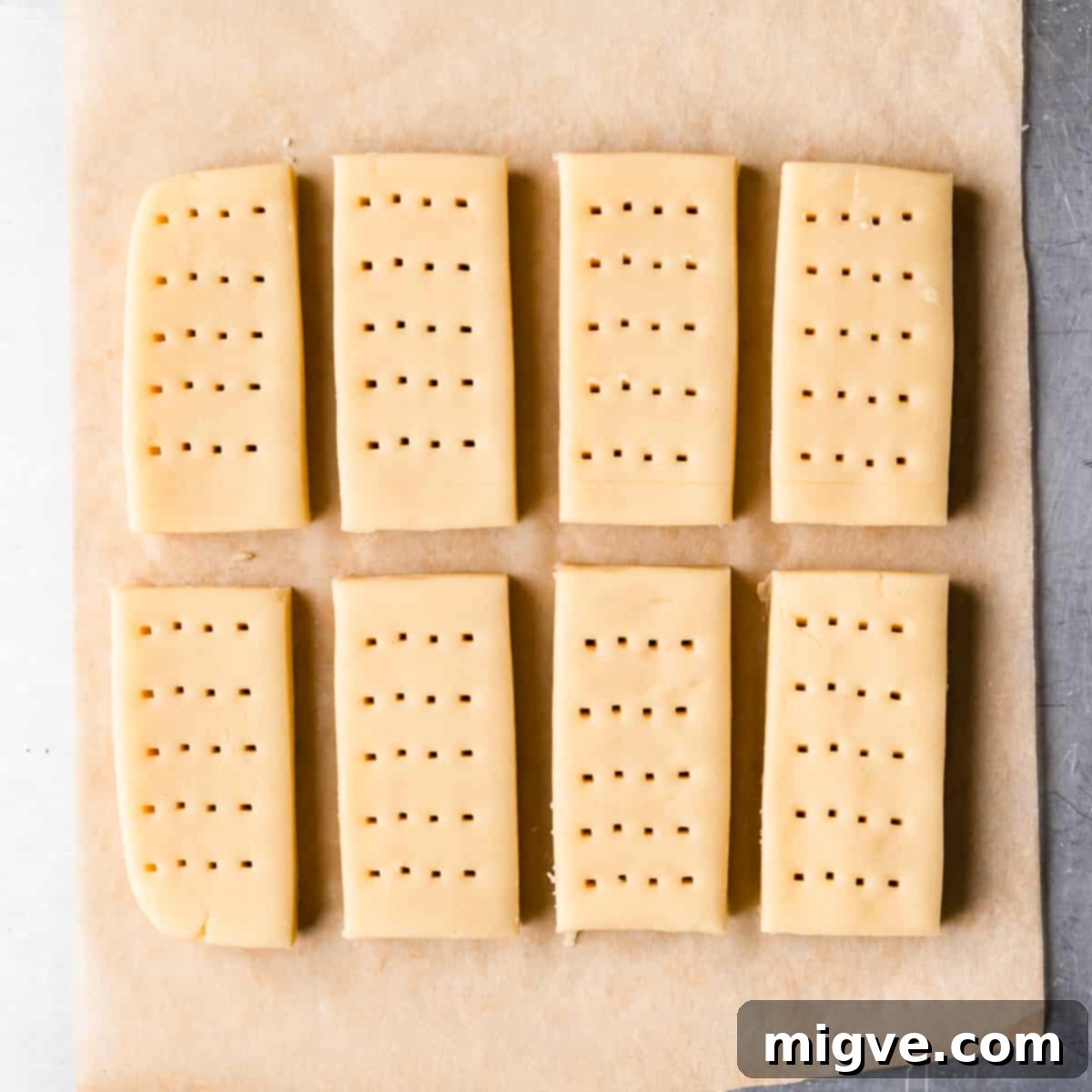 Shortbread dough sliced into 8 fingers and gently pricked with a fork on top, ready for chilling.
