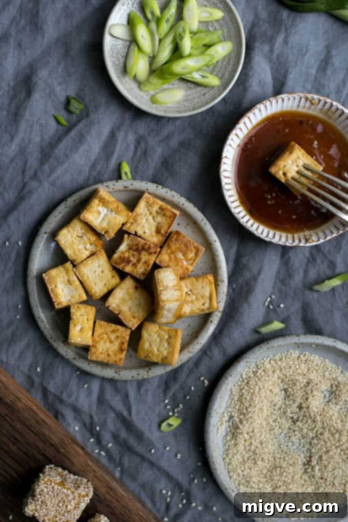 Golden sticky tofu coated in sesame seeds, served alongside perfectly cooked soba noodles and crunchy pickled zucchini