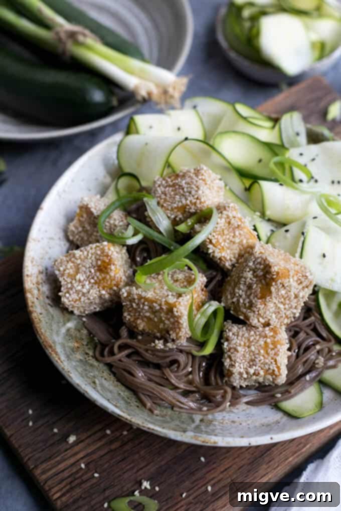 Soba noodles paired with perfectly pan-fried sticky tofu, generously coated in crunchy sesame seeds