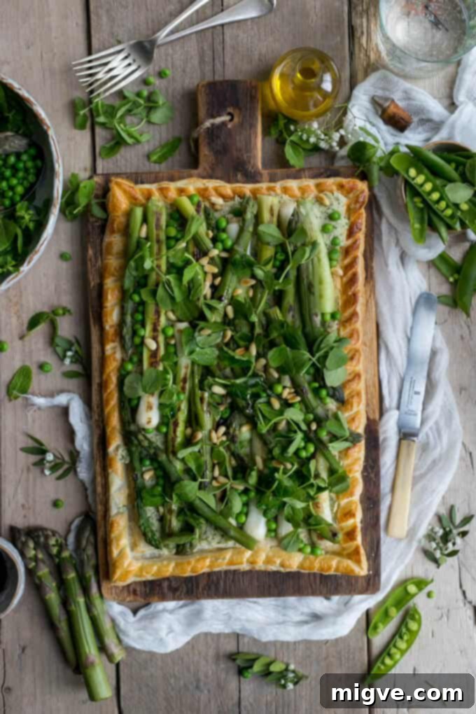 Charred asparagus tart with pea shoots and baby leeks. A delightful vegetarian tart perfect for spring gatherings.
