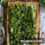 Charred asparagus tart with baby leeks, peas, pea shoots and fresh herbs