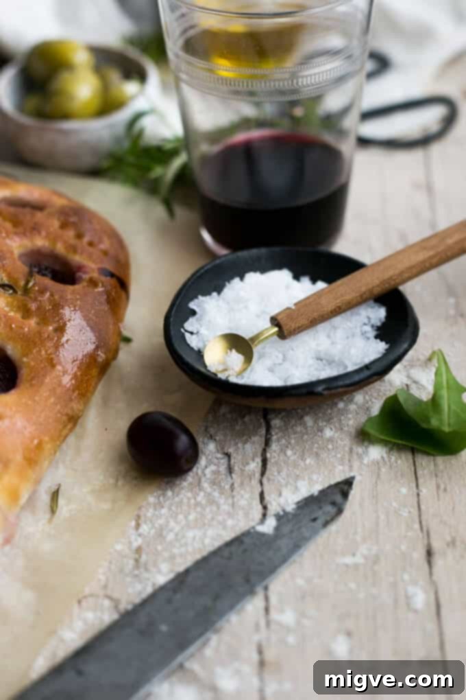 Rustic rosemary focaccia with roasted red grapes, beautifully styled for a culinary blog