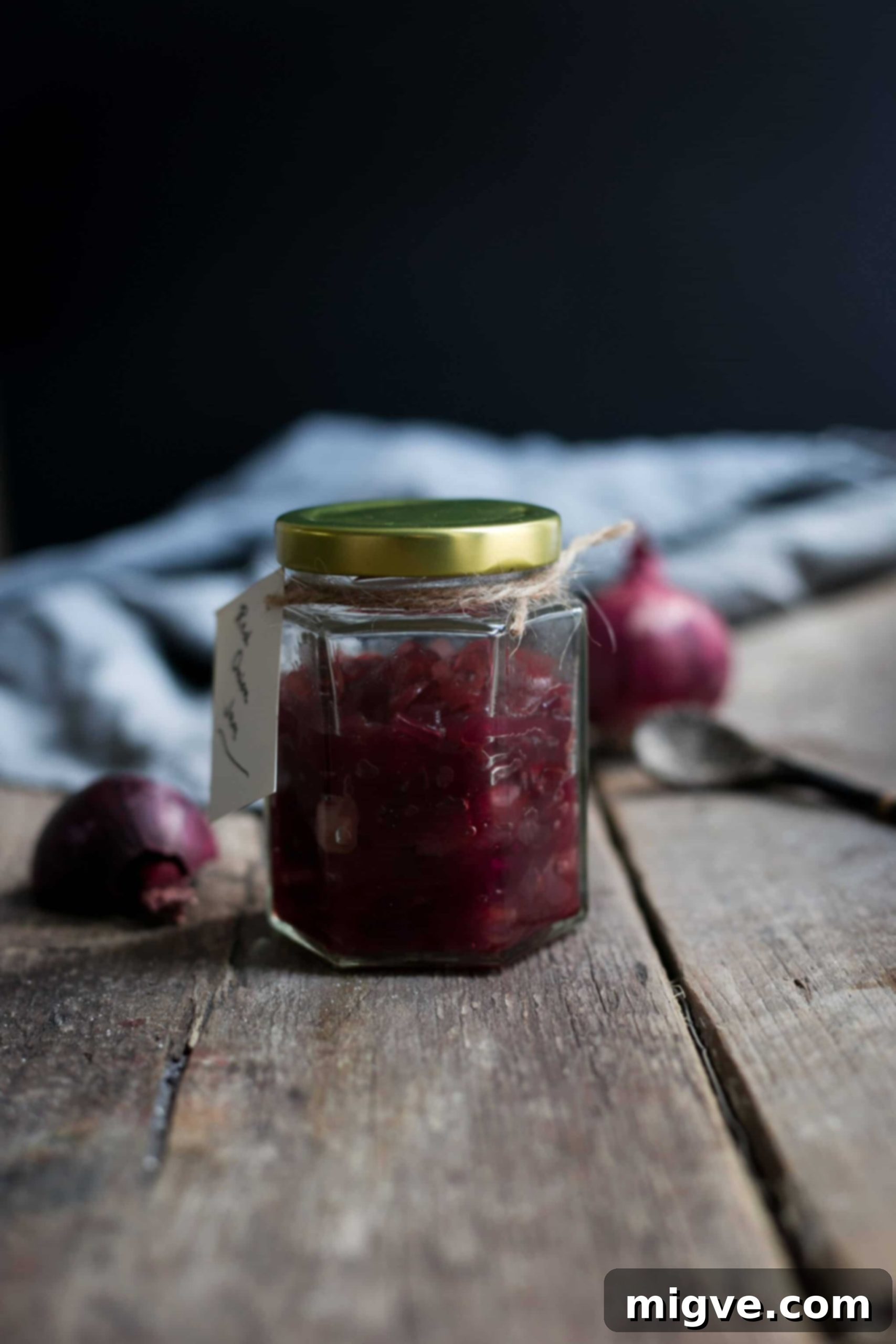 Close-up of a jar of homemade Red Onion Jam, showcasing its rich color and texture