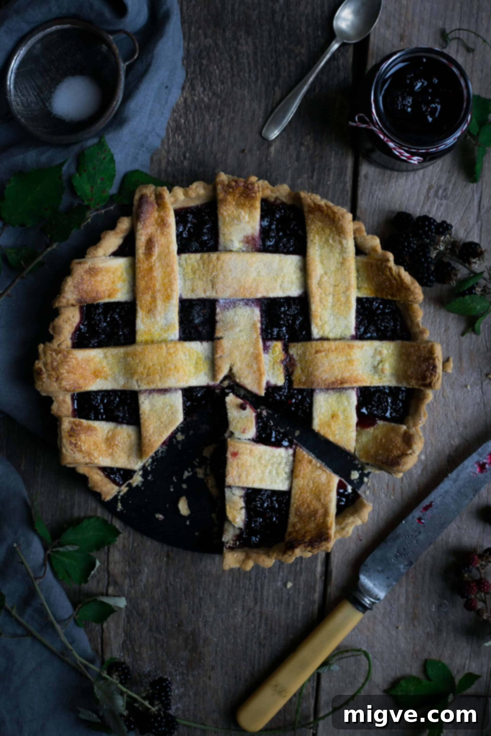 Rustic homemade blackberry jam lattice tart with fresh blackberries