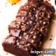 Slices of chocolate pumpkin loaf with chocolate chips on top.