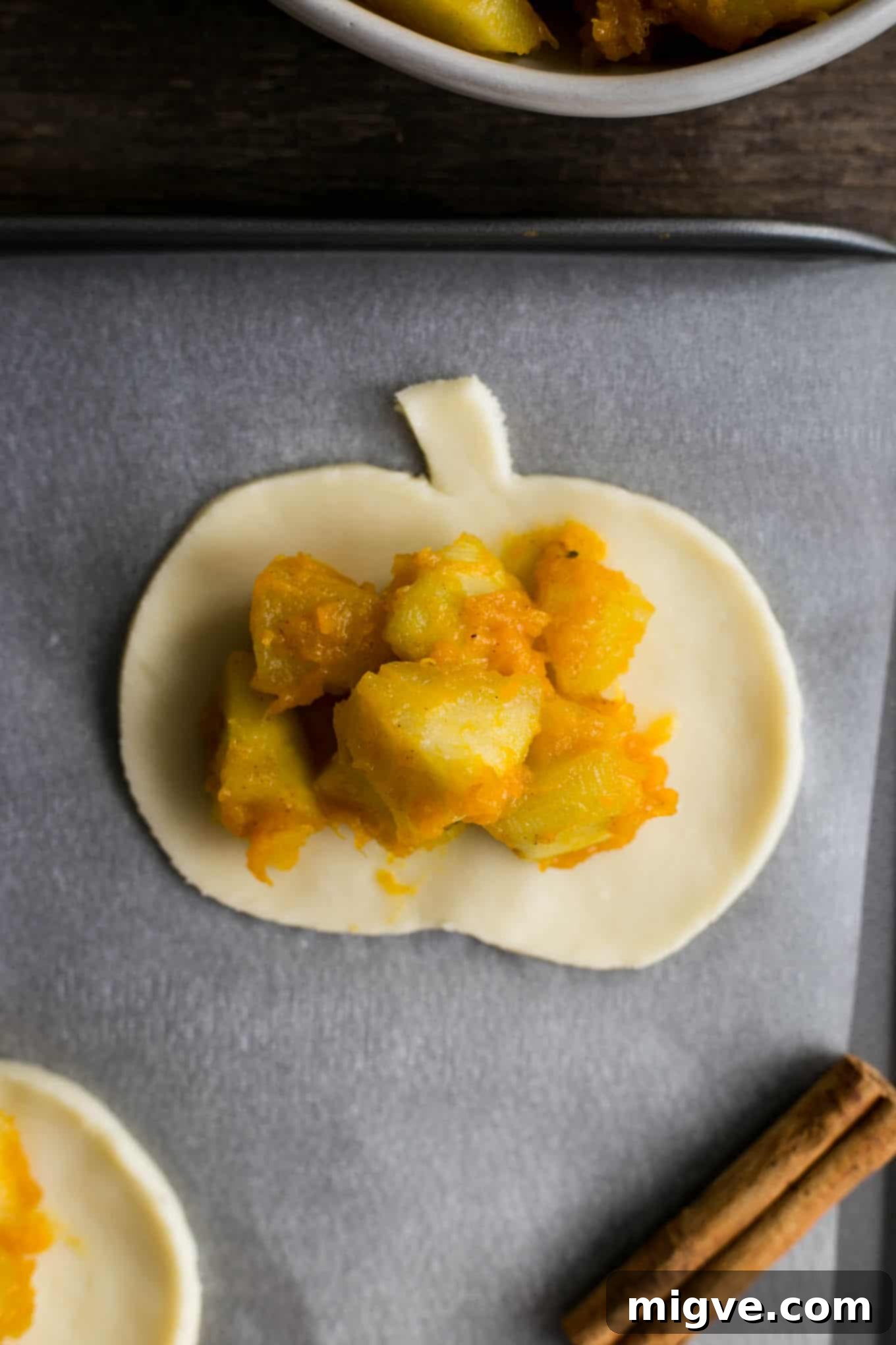 Warm Spiced Apple Pumpkin Pockets 4 Delicious spiced apple and pumpkin hand pies arranged on a serving plate.