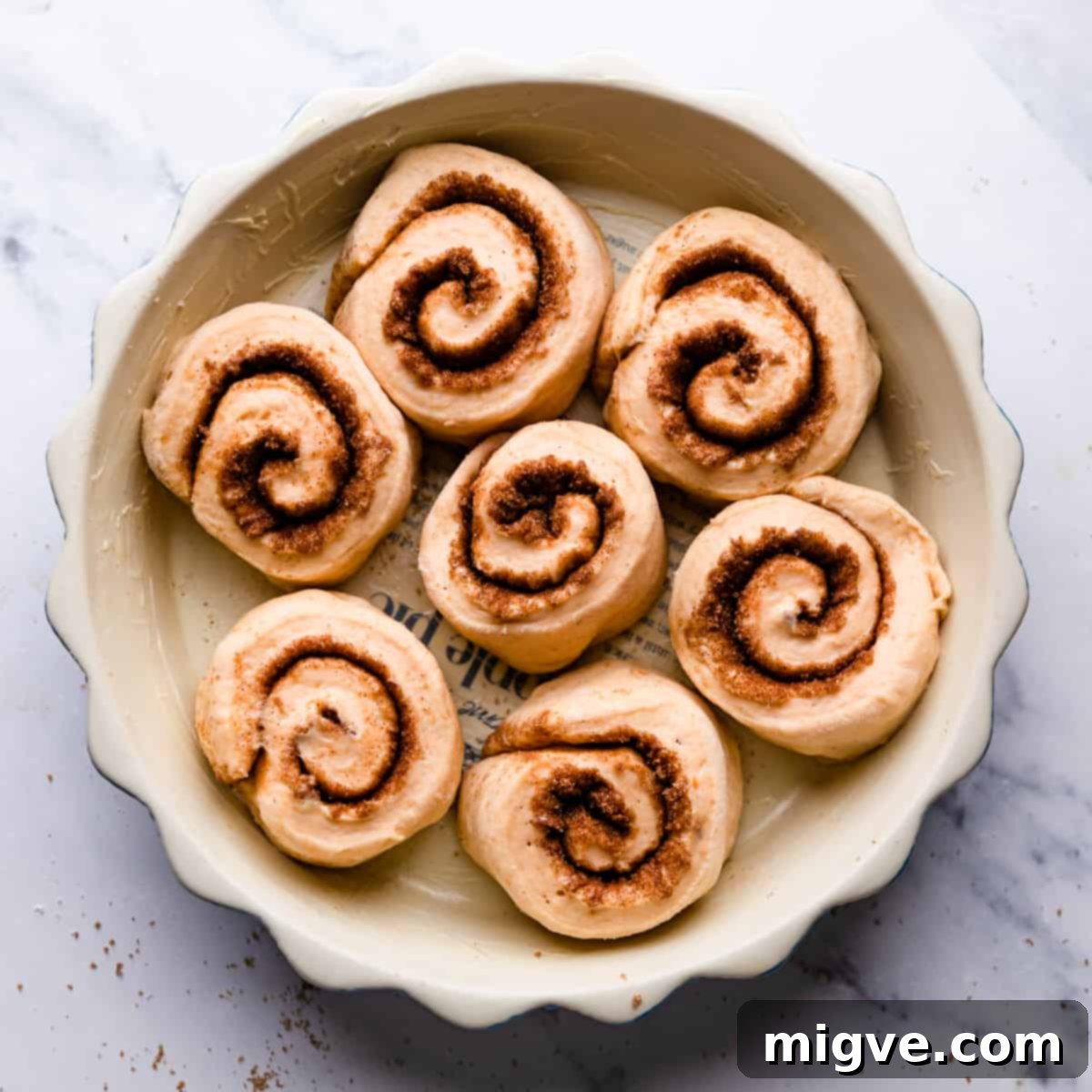 7 slices of cinnamon rolls inside of the greased round pie dish.