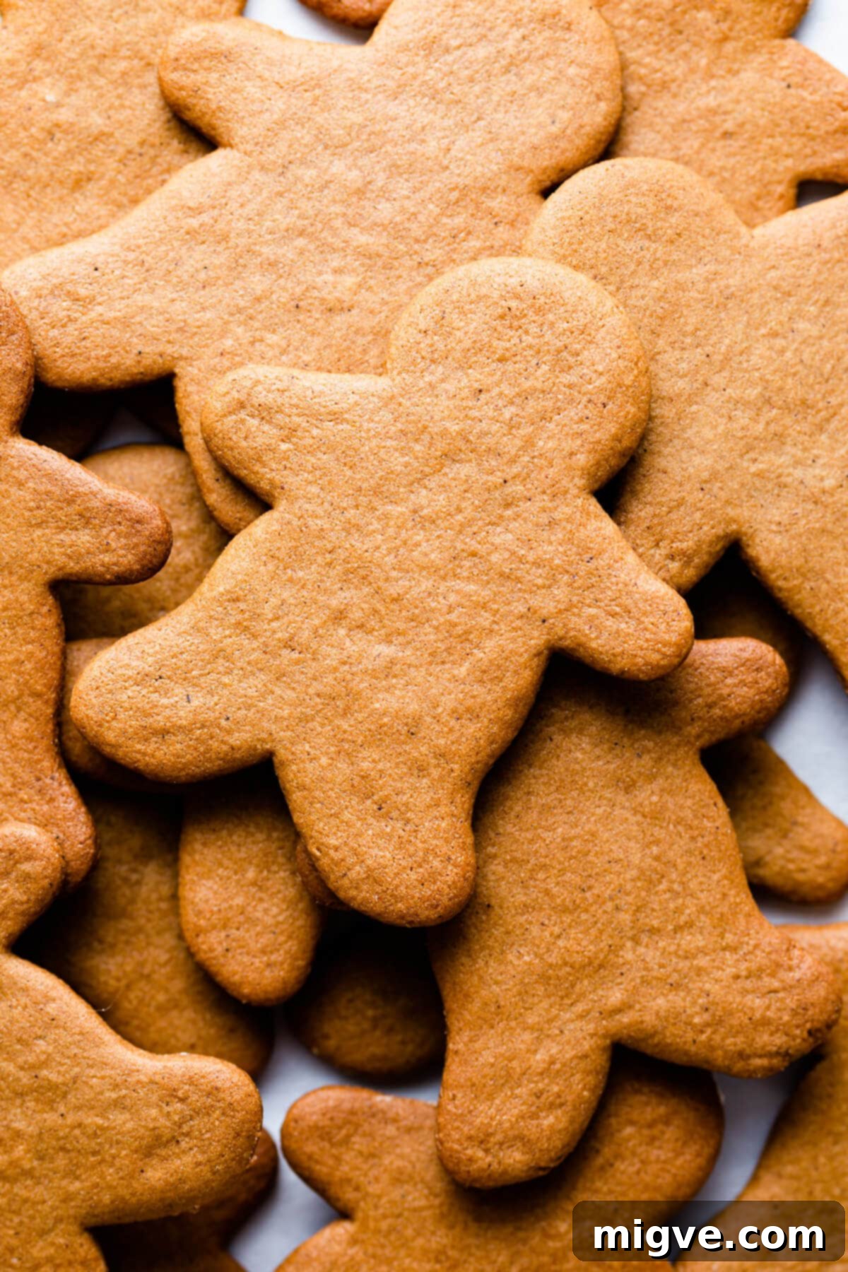 Pillowy Soft Gingerbread Cookies 8 Close-up, top-down view of a freshly baked gingerbread man cookie, showing its warm, spiced surface texture.