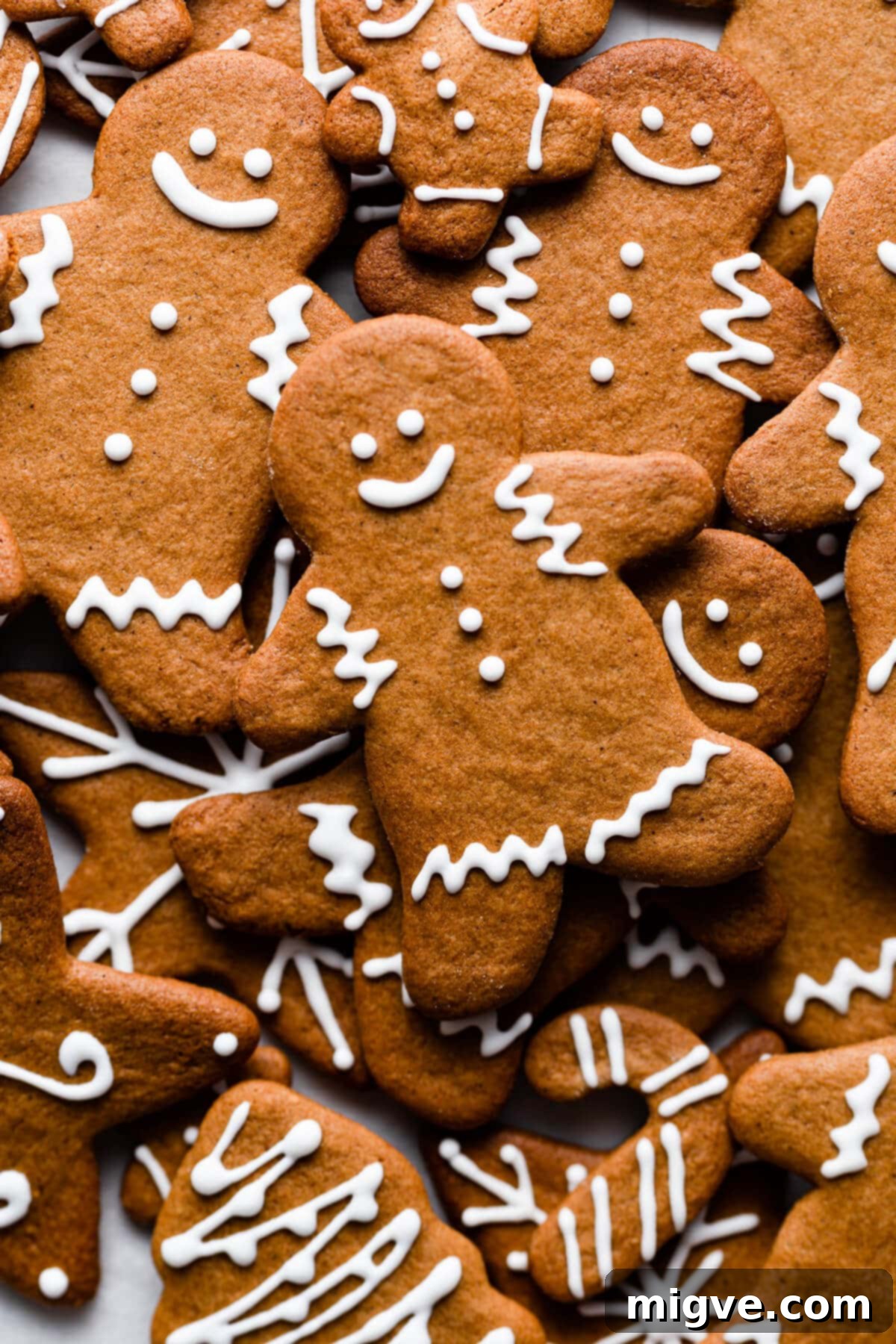 Pillowy Soft Gingerbread Cookies 10 Super close-up, top-down view of beautifully decorated soft gingerbread cookies with white icing, showcasing intricate details and festive charm.