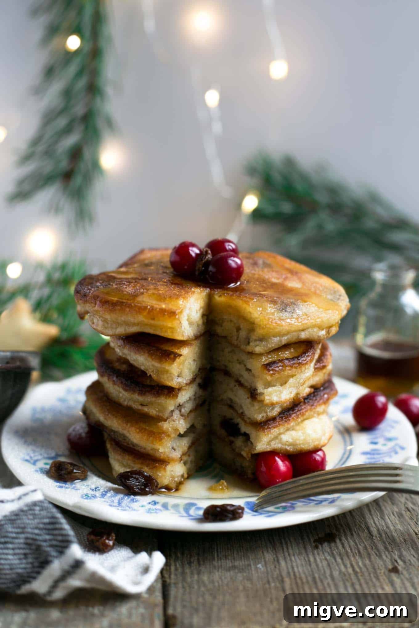 The fluffiest vegan pancakes with boozy dark rum-soaked raisins, ideal for Christmas breakfast or brunch.