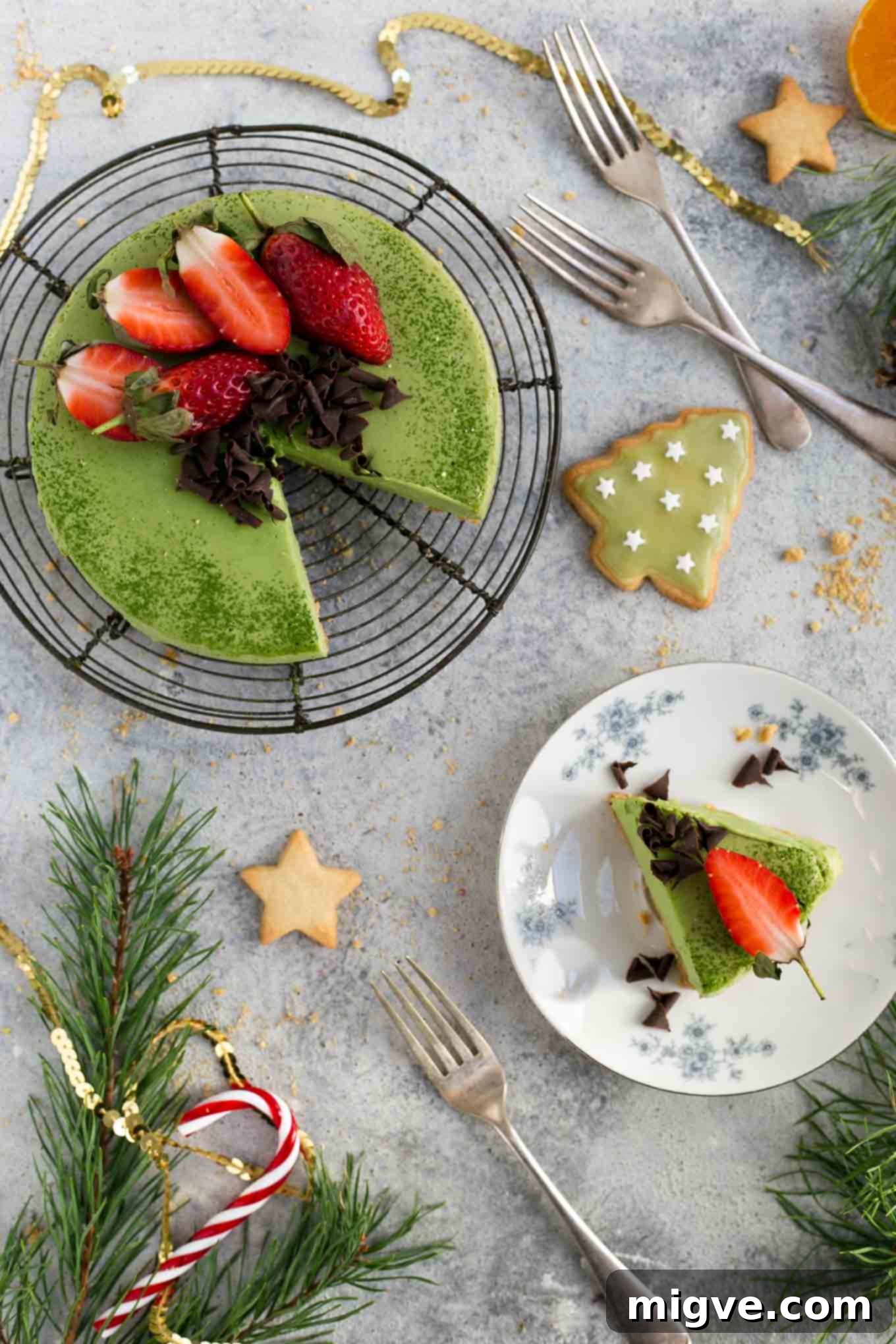 An entire vegan matcha ginger cheesecake beautifully presented on a stand, ready to be served, making it an excellent dairy-free Christmas dessert.