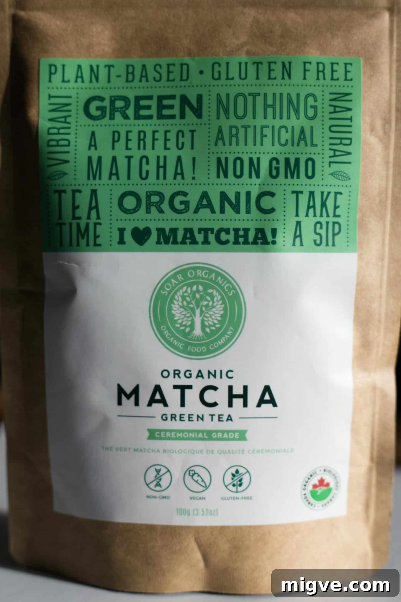 A whole vegan matcha ginger cheesecake with a rich, green filling and a spiced biscuit base, ready to be enjoyed as a festive, healthy dessert.