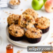 45 degree angle close up of 6 apple muffins on a plate