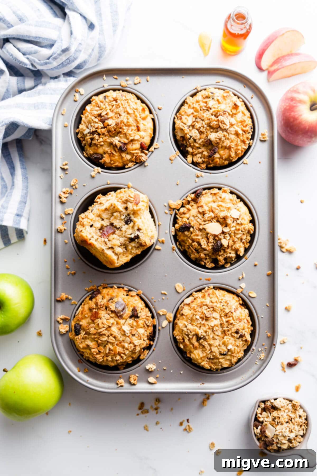 top view of baking tin with 6 apple and granola breakfast muffins inside