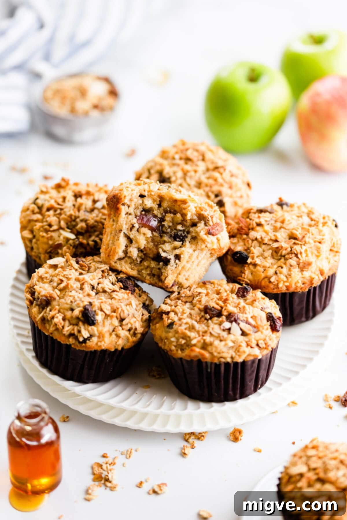 45 degree angle close up of apple and granola breakfast muffins on a plate